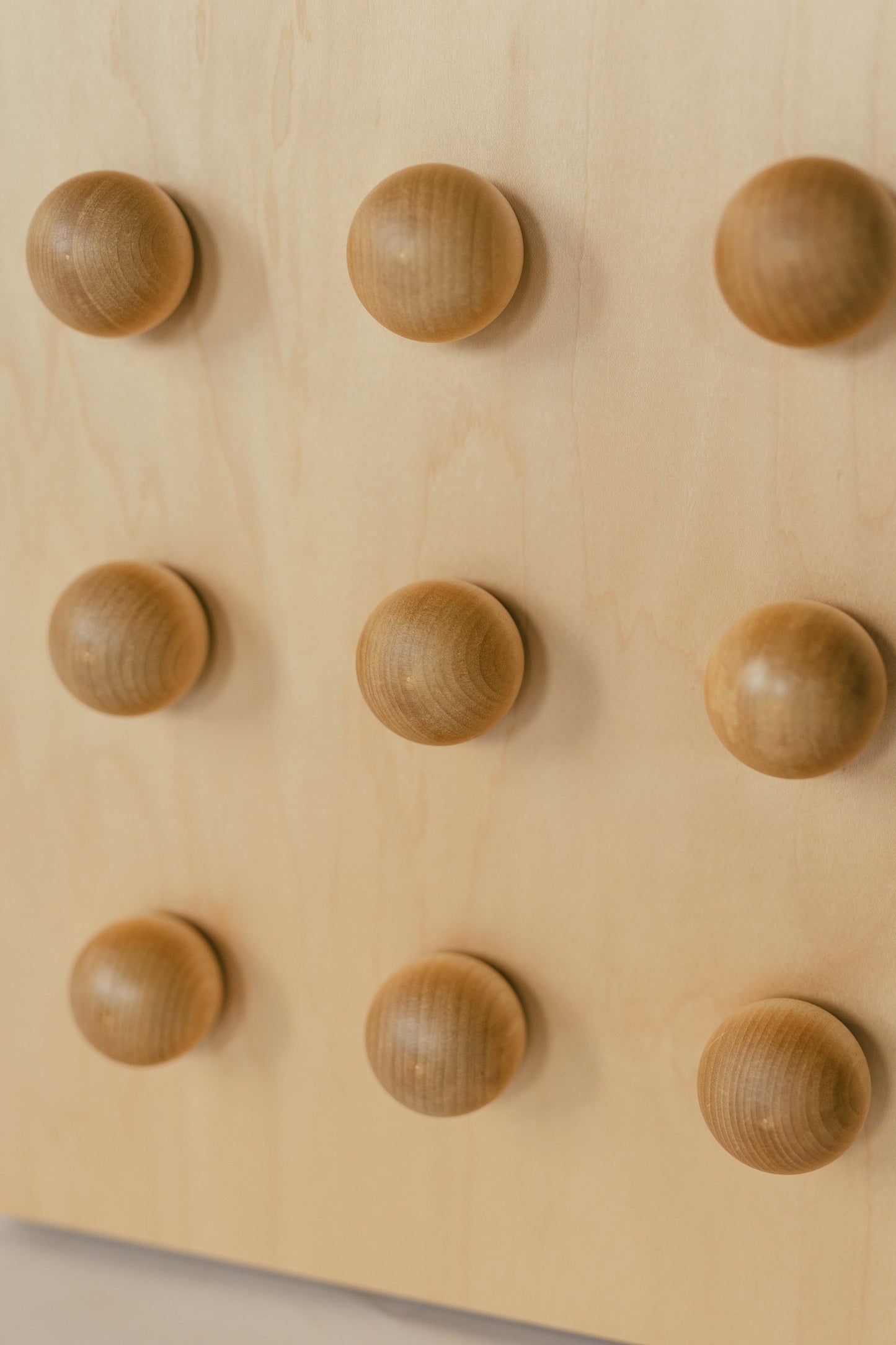Wooden sculptural accent table on a light gray background