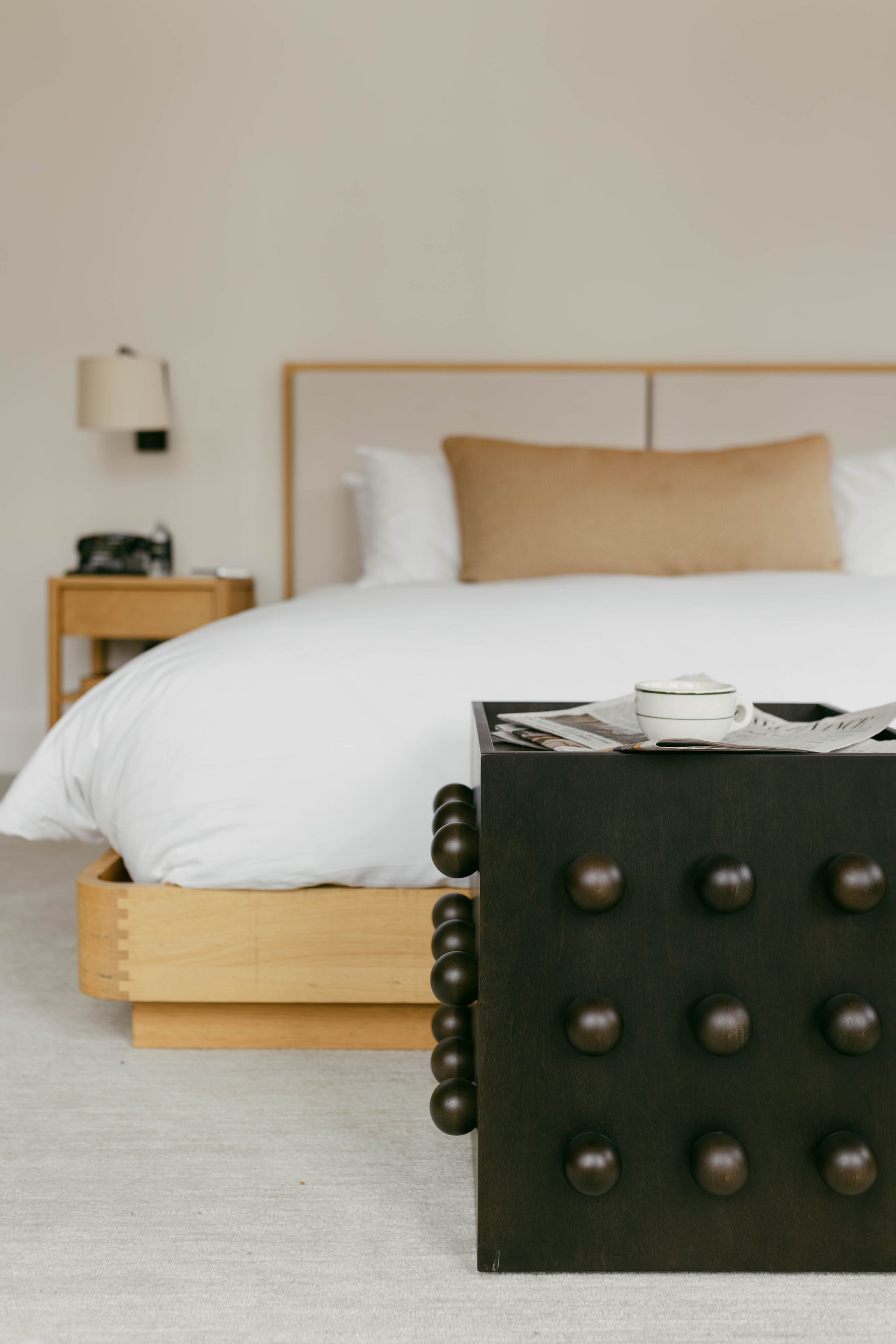 Bedroom with a bed, nightstand, and decorative box in a neutral setting