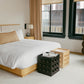 Modern bedroom with a bed, nightstands, and a chair.