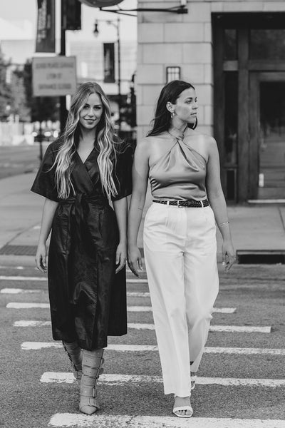 luxury furniture designers styled well walking down the street, crosswalk. 