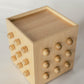 Wooden sculptural accent table on a light gray background