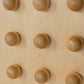 Wooden sculptural accent table on a light gray background