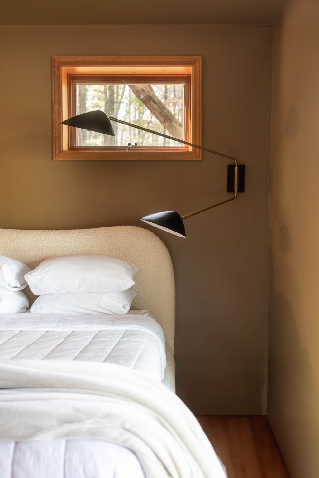 layered warm tone bedroom, color drenched bedroom, white boucle bedroom, bedroom inspiration. oversized light, layered bedding.
