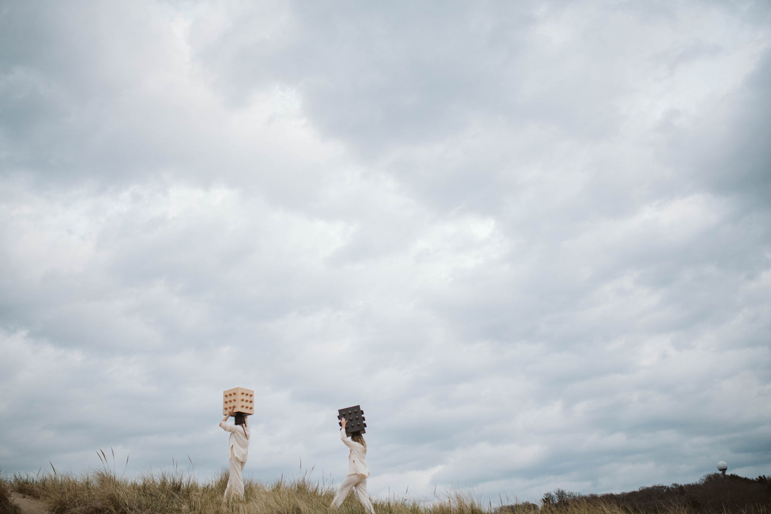 etherial dune shoot carrying lux hand crafted accent tables under a cloud covered sky.